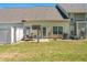 A spacious backyard features green grass, a patio with an outdoor seating area, and an AC unit at 949 Pike Forest Dr, Lawrenceville, GA 30045