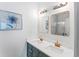 Elegant bathroom featuring double sinks, modern lighting, and stylish framed mirrors at 949 Pike Forest Dr, Lawrenceville, GA 30045