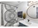 Well-lit bathroom with stylish vanity, modern fixtures, decorative shower curtain, and ample counter space at 949 Pike Forest Dr, Lawrenceville, GA 30045