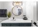 Stylishly updated bathroom features a modern vanity, a round mirror, and sleek fixtures, showcasing a contemporary design at 949 Pike Forest Dr, Lawrenceville, GA 30045