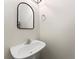 Bathroom featuring a pedestal sink and a modern mirror at 949 Pike Forest Dr, Lawrenceville, GA 30045
