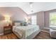 Bright bedroom with hardwood floors, neutral tones, and large windows offering natural light and a tranquil atmosphere at 949 Pike Forest Dr, Lawrenceville, GA 30045