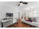 Bright bedroom featuring a work space, modern ceiling fan, and hardwood floors at 949 Pike Forest Dr, Lawrenceville, GA 30045
