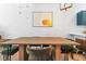 Dining table with upholstered chairs and a large art piece on the wall at 949 Pike Forest Dr, Lawrenceville, GA 30045
