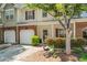 Charming two-story townhome with brick accents, attached garage, and landscaped front yard, offering curb appeal at 949 Pike Forest Dr, Lawrenceville, GA 30045