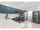 Modern kitchen with stainless steel appliances, quartz countertops, and ample cabinet space at 949 Pike Forest Dr, Lawrenceville, GA 30045