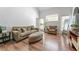 Cozy living room with hardwood floors, comfortable seating, and ample natural light at 949 Pike Forest Dr, Lawrenceville, GA 30045