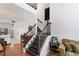 Elegant staircase with dark wood steps and railing, complemented by light walls at 949 Pike Forest Dr, Lawrenceville, GA 30045