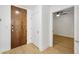 Hallway with wood-look flooring leading to a bedroom; a storage closet is also visible at 171 Auburn Ne Ave # 210, Atlanta, GA 30303