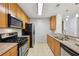 Galley kitchen showcasing granite counters, stainless appliances, and light wood cabinetry at 171 Auburn Ne Ave # 210, Atlanta, GA 30303