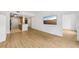 Open-concept living space with kitchen area, hard floors, and large TV at 171 Auburn Ne Ave # 210, Atlanta, GA 30303