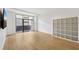 Bright living room with balcony access, wood-look floors, and modern shelving unit at 171 Auburn Ne Ave # 210, Atlanta, GA 30303