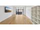 Bright living room with balcony access, wood-look floors, and modern shelving unit at 171 Auburn Ne Ave # 210, Atlanta, GA 30303