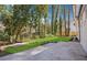 Manicured backyard with newly planted grass and a large concrete patio at 335 Amberidge Nw Trl, Atlanta, GA 30328