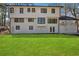 Expansive backyard with lush green grass, an outdoor porch, and access to woods at 335 Amberidge Nw Trl, Atlanta, GA 30328