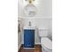 Stylish powder room with blue vanity, gold fixtures, and white wainscoting at 335 Amberidge Nw Trl, Atlanta, GA 30328