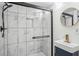 Modern bathroom with sleek glass shower, and round mirror at 335 Amberidge Nw Trl, Atlanta, GA 30328