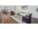 Open concept living room with hardwood floors, comfortable seating, and a view of the modern kitchen at 335 Amberidge Nw Trl, Atlanta, GA 30328