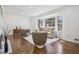Sun-filled living room featuring hardwood floors, neutral furnishings, and a large bay window with wooded views at 335 Amberidge Nw Trl, Atlanta, GA 30328