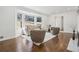 Bright living room with hardwood flooring, bay window views, and stylish, comfortable seating on a white rug at 335 Amberidge Nw Trl, Atlanta, GA 30328