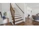 Bright staircase featuring hardwood steps, a white riser, and a dark wood banister leading to the upper level at 335 Amberidge Nw Trl, Atlanta, GA 30328
