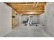Unfinished basement with exposed framing and concrete walls features an exercise area with workout equipment at 11180 West Rd, Roswell, GA 30075