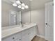 Bright bathroom featuring a large mirror and white vanity with ample storage at 11180 West Rd, Roswell, GA 30075