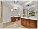 Elegant bathroom boasts dual vanities, tiled floors, and a separate shower area, combining functionality with timeless design at 11180 West Rd, Roswell, GA 30075