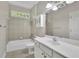 Well-lit bathroom with a tub, shower, and ample counter space at 11180 West Rd, Roswell, GA 30075
