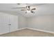 Neutral bedroom with carpet, double closets, ceiling fan and baseboard molding at 11180 West Rd, Roswell, GA 30075