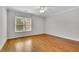 Bedroom with hardwood flooring and large windows allowing for natural light at 11180 West Rd, Roswell, GA 30075
