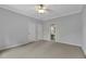Carpeted bedroom features a ceiling fan, two closets, and an attached bathroom at 11180 West Rd, Roswell, GA 30075