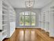 Large walk-in closet with custom shelving and storage solutions, enhanced by a window allowing natural light to illuminate the space at 11180 West Rd, Roswell, GA 30075