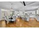Open-concept dining area with hardwood floors and view to kitchen at 11180 West Rd, Roswell, GA 30075