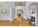 Elegant foyer featuring hardwood floors, a high ceiling, arched doorways, and a decorative bench at 11180 West Rd, Roswell, GA 30075