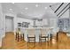 Bright kitchen island with seating, white cabinets, and modern appliances at 11180 West Rd, Roswell, GA 30075