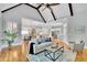 Bright living room with hardwood floors, vaulted ceiling, and an open layout that seamlessly connects to the kitchen and dining areas at 11180 West Rd, Roswell, GA 30075