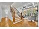 Open-concept living area featuring hardwood floors, a staircase, and an abundance of natural light at 11180 West Rd, Roswell, GA 30075