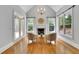Cozy sitting area within the main bedroom features large windows and a fireplace, creating a relaxing retreat at 11180 West Rd, Roswell, GA 30075