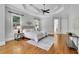 Elegant main bedroom offers a tray ceiling, hardwood floors, and plenty of natural light for a tranquil and airy atmosphere at 11180 West Rd, Roswell, GA 30075
