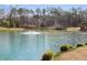 Tranquil pond with fountain, surrounded by trees and vegetation, creating a serene and picturesque setting at 11180 West Rd, Roswell, GA 30075