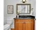 Elegant powder room with dark granite countertop and decorative mirror at 11180 West Rd, Roswell, GA 30075