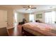 Bright bedroom with hardwood floors, a ceiling fan, and access to an ensuite bathroom at 2545 Lake Royale Dr, Riverdale, GA 30296