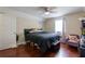 Cozy bedroom features wood floors, ceiling fan, and a comfortable bed for a restful retreat at 2545 Lake Royale Dr, Riverdale, GA 30296