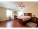 Spacious main bedroom boasts wood floors, ceiling fan, and natural light from large windows at 2545 Lake Royale Dr, Riverdale, GA 30296