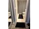 Bathroom with dual entry, tiled floor, toilet, and striped shower curtain at 795 Hammond Dr # 813, Sandy Springs, GA 30328