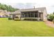 Expansive backyard with manicured lawn, landscaping, and a screened-in porch at 1889 Raegan Way, Lawrenceville, GA 30043