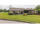 Spacious backyard with a patio, green lawn, and mature landscaping at 1889 Raegan Way, Lawrenceville, GA 30043