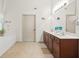 Bright bathroom with double vanity, soaking tub, and tiled floor at 1889 Raegan Way, Lawrenceville, GA 30043