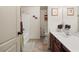 Well-lit bathroom with a shower-tub combo, a toilet, and a vanity with a sink at 1889 Raegan Way, Lawrenceville, GA 30043